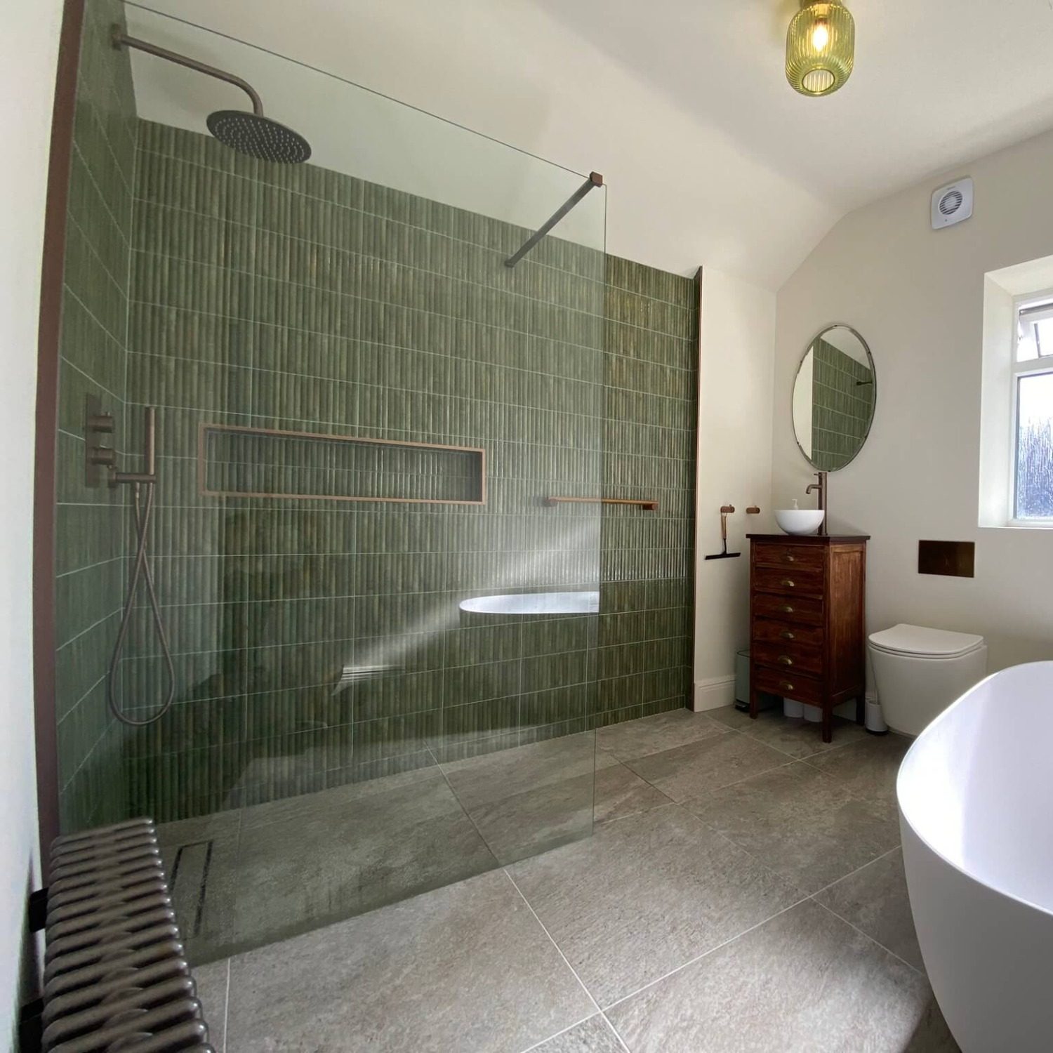 Southville bathroom with green tiled walk-in shower, wooden vanity and freestanding bath